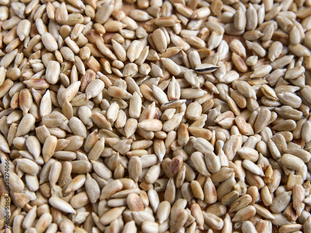 Sunflower seeds peeled on a wooden table, top view. Sunflower seeds peeled on a wooden table, top view.