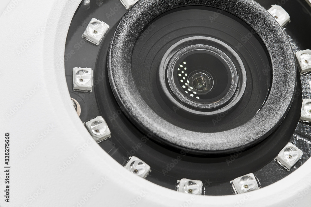 Obraz premium Dome secure camera on light background with motion sensors. Video surveillance camera. Closeup, selective focus