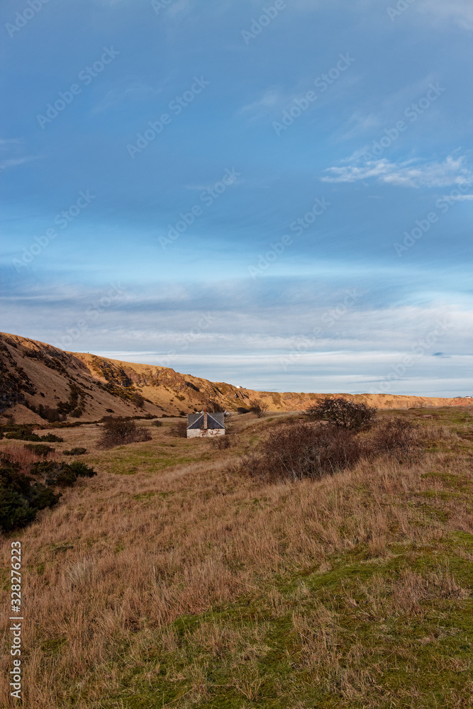 An abandoned Fishermen's Cottage and Ice house set back from the beach at St Cyrus, beneath the Volcanic Cliffs.