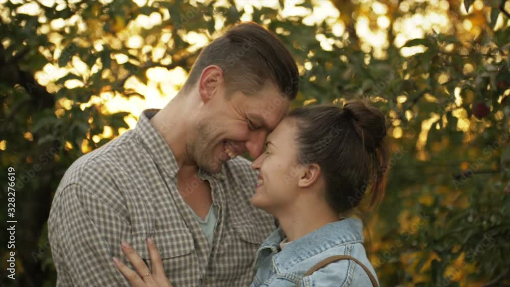Young Caucasian couple kissing and cuddling during their romantic date in breathtaking autumn nature. Young Caucasian couple kissing and cuddling during their romantic date in breathtaking autumn nature.