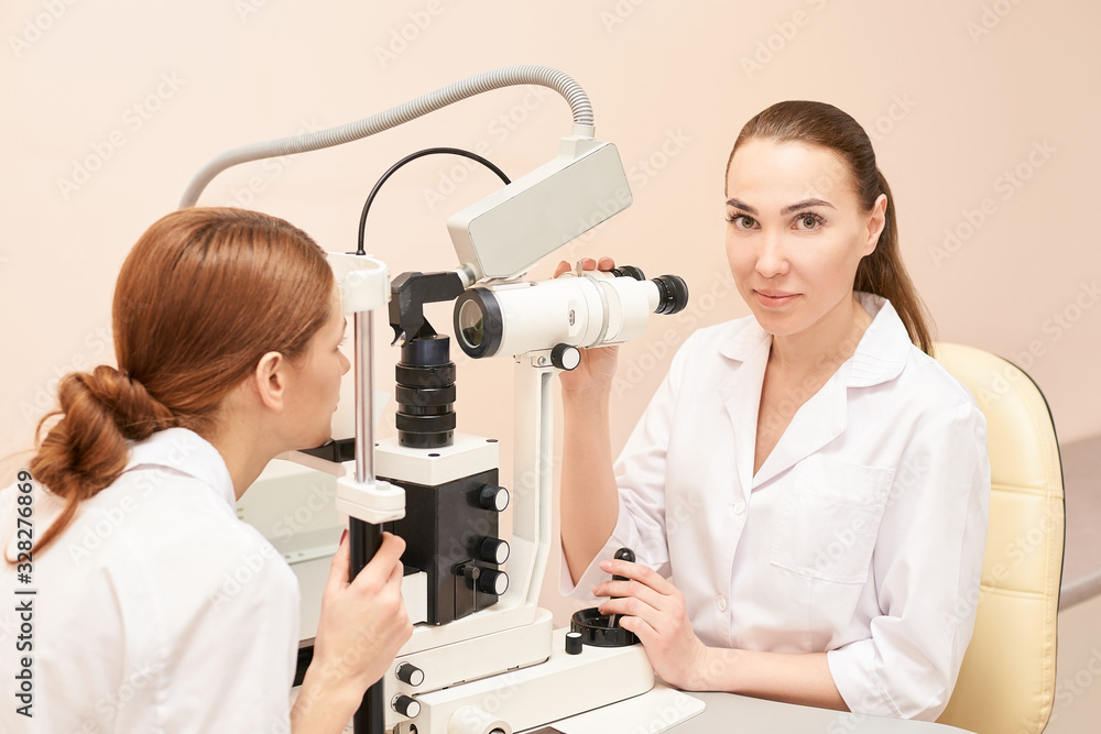 ophthalmologist doctor in exam optician laboratory with female patient. Eye care medical diagnostic. Eyelid treatment ophthalmologist doctor in exam optician laboratory with female patient. Eye care medical diagnostic. Eyelid treatment