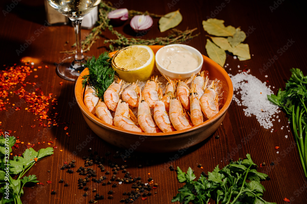 Grilled shrimps or prawns served with lemon and sauce