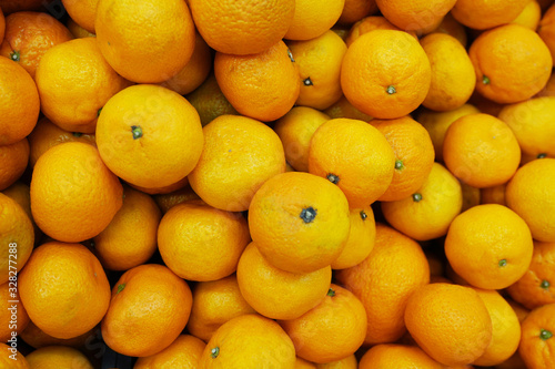 Healthy fruits, mandarin fruits background. Orange fruit background. Mandarin fruits at market store