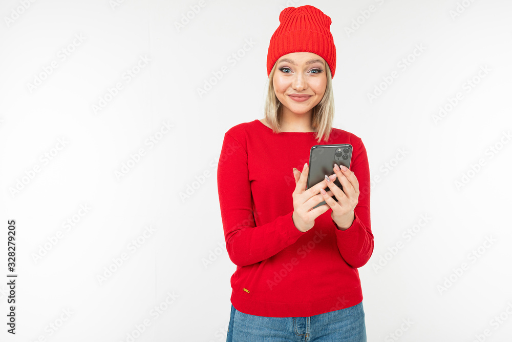 smiling girl in red clothes surfing the internet on a white background with copy space smiling girl in red clothes surfing the internet on a white background with copy space