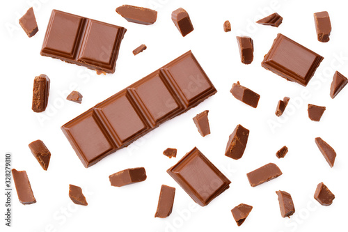Milk chocolate pieces isolated on white background. top view