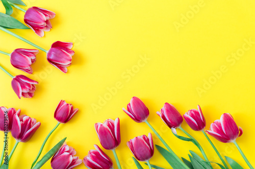 8 March Happy Women's Day. Easter and spring greeting card. Spring concept. Pink Purple tulips on yellow background. Copy space. Spring banner. Woman day concept. Copyspace for text.