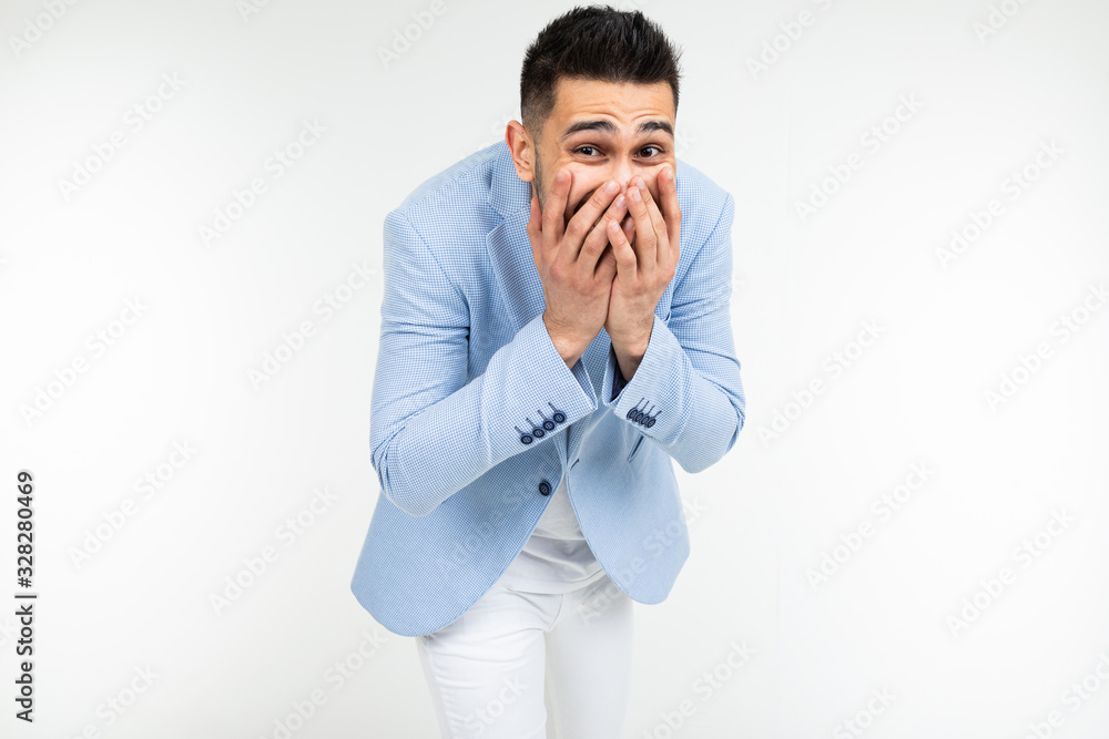 handsome man in classic style laughs covering his mouth with his hand on a white background isolated handsome man in classic style laughs covering his mouth with his hand on a white background isolated