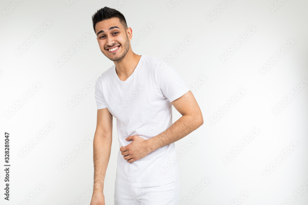 Caucasian man holding his hands on his stomach on a white studio background with copy space Caucasian man holding his hands on his stomach on a white studio background with copy space