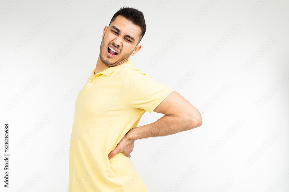 young man pulled back muscle on a white studio background with copy