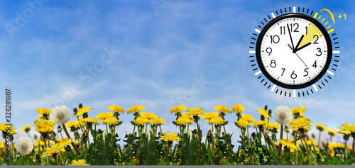 Daylight Saving Time (DST) Wall Clock on spring landscape. Turn time forward. Abstract photo of changing time at spring.