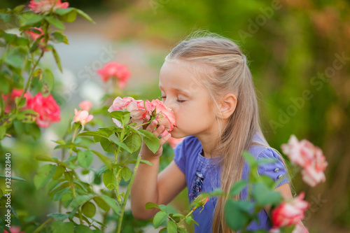 Portrait of a beautiful girl in the garden of a tea rose in spring.