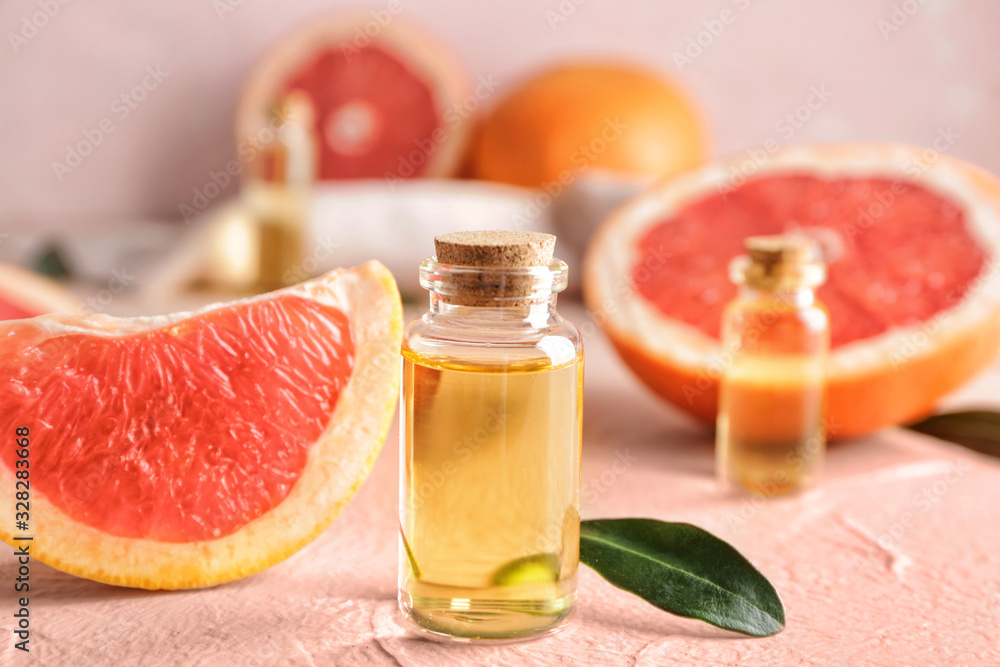 Bottles of grapefruit essential oil on table Bottles of grapefruit essential oil on table