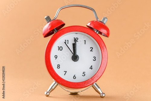 Red alarm clock on a light background