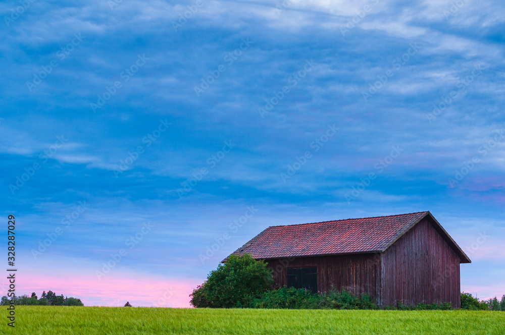Wooden barn on green field Wooden barn on green field