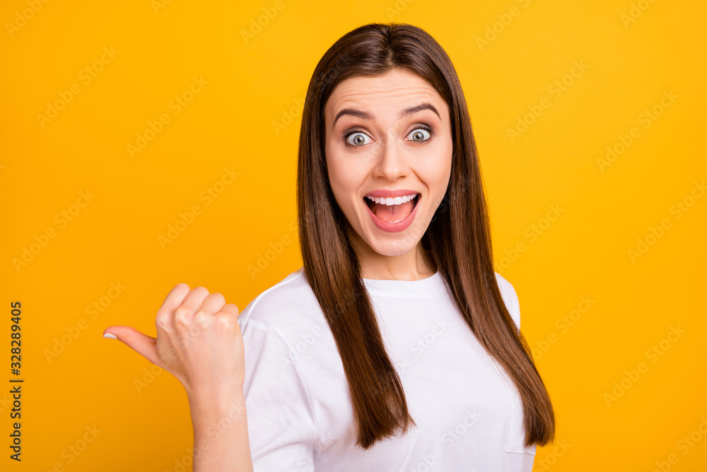 SALE. Photo of pretty nice business lady directing thumb finger side empty space cool offer open mouth wear casual white t-shirt isolated vivid yellow color background SALE. Photo of pretty nice business lady directing thumb finger side empty space cool offer open mouth wear casual white t-shirt isolated vivid yellow color background