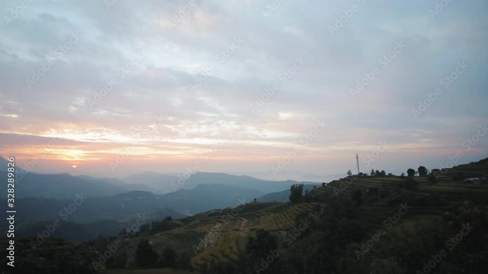 A beautiful view of nepalese rice terraced fields at sunset, sunrise. Hills, mountains, rural landscape. A beautiful view of nepalese rice terraced fields at sunset, sunrise. Hills, mountains, rural landscape.