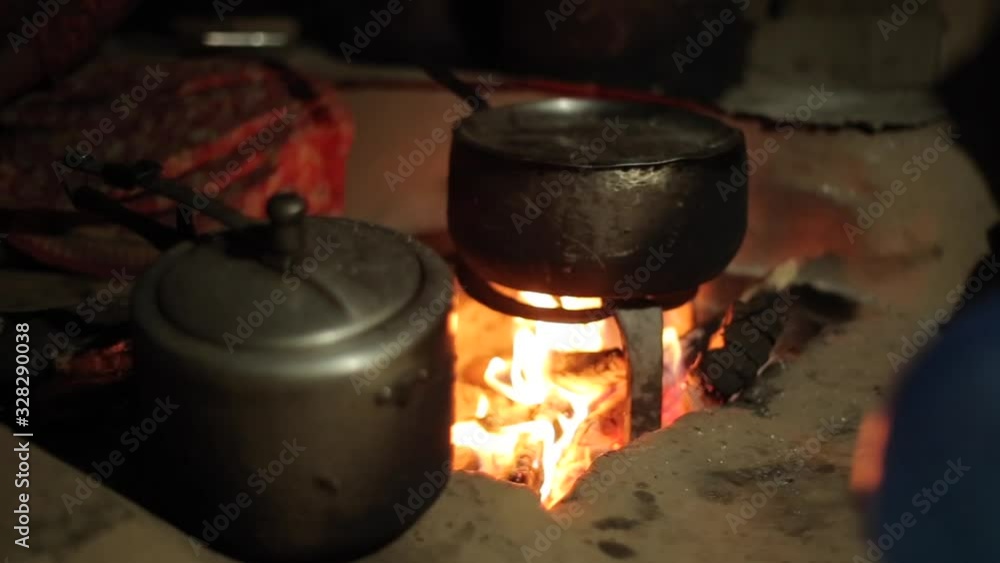 A close up on an old kettle, saucepan placed above fire. Nepalese village. A close up on an old kettle, saucepan placed above fire. Nepalese village.