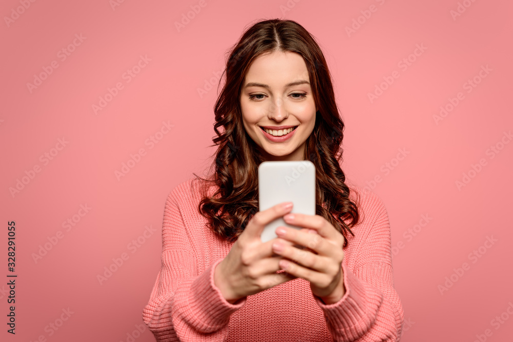 happy girl smiling while having video chat on smartphone isolated on pink happy girl smiling while having video chat on smartphone isolated on pink