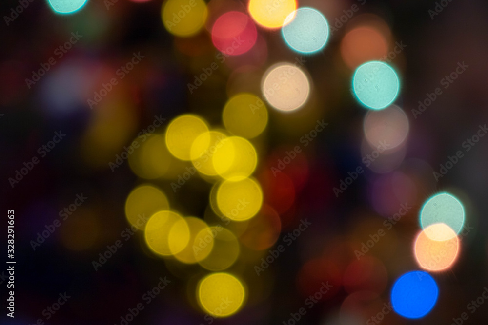 Fototapeta premium abstract Red glitter lights background. defocused. Colorful light bulbs and vivid round bokeh lights tree festive mood lightning