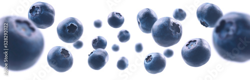 Ripe blueberries levitate on a white background