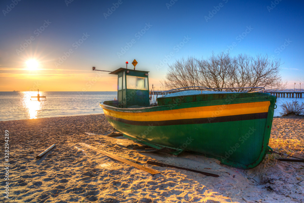 Fishing boats on the Baltic Sea beach at sunrise in Gdynia Orlowo, Poland
