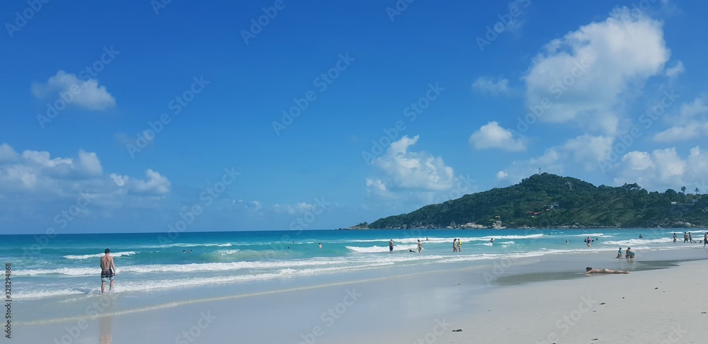 view of the beach with blue sky and clouds