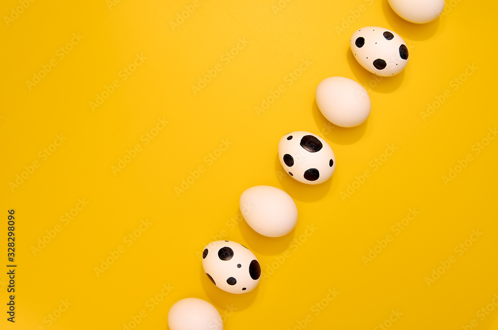 Naklejka premium Many White eggs with green myrtle leaves pattern on yellow color background. Spring and Easter holiday concept with copy space.