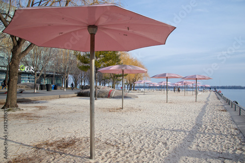 Beach chairs with umbrella in sunset