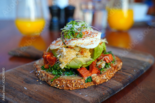Multigrain avocado toast with fried egg on top