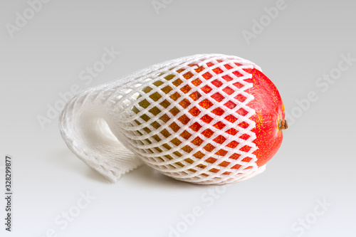 Mango fruit in a mesh packaging made of food foam for fruit