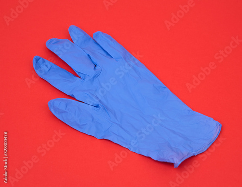 blue medical rubber glove for carrying out procedures and manipulations © nndanko