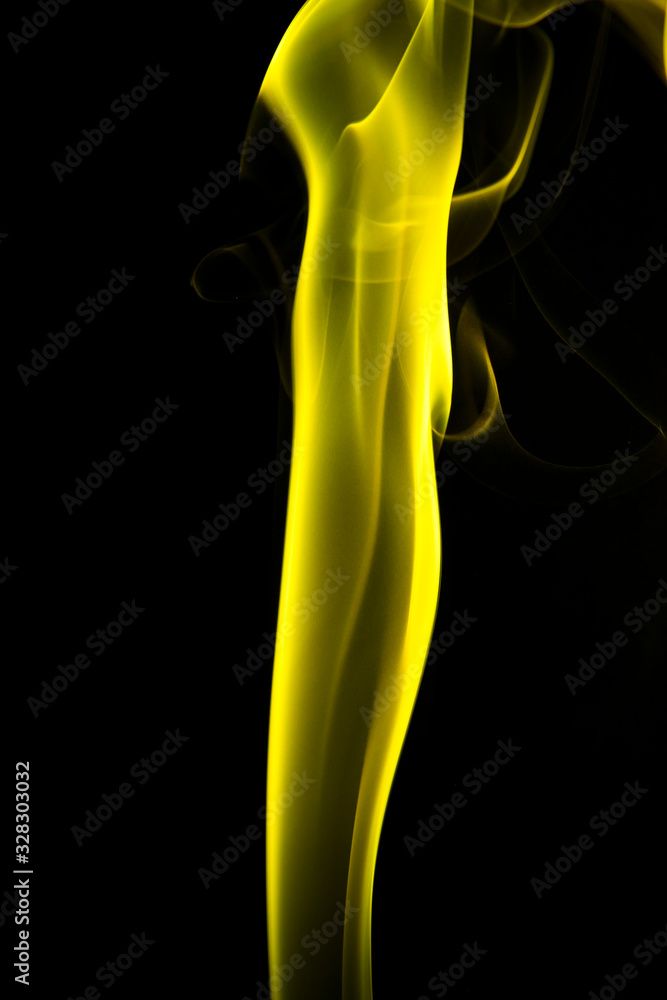 Obraz premium Yellow smoke on black background