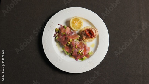 Tartar of fish with pumpkin seeds, with fish paste with sun-dried tomato and lemon. 