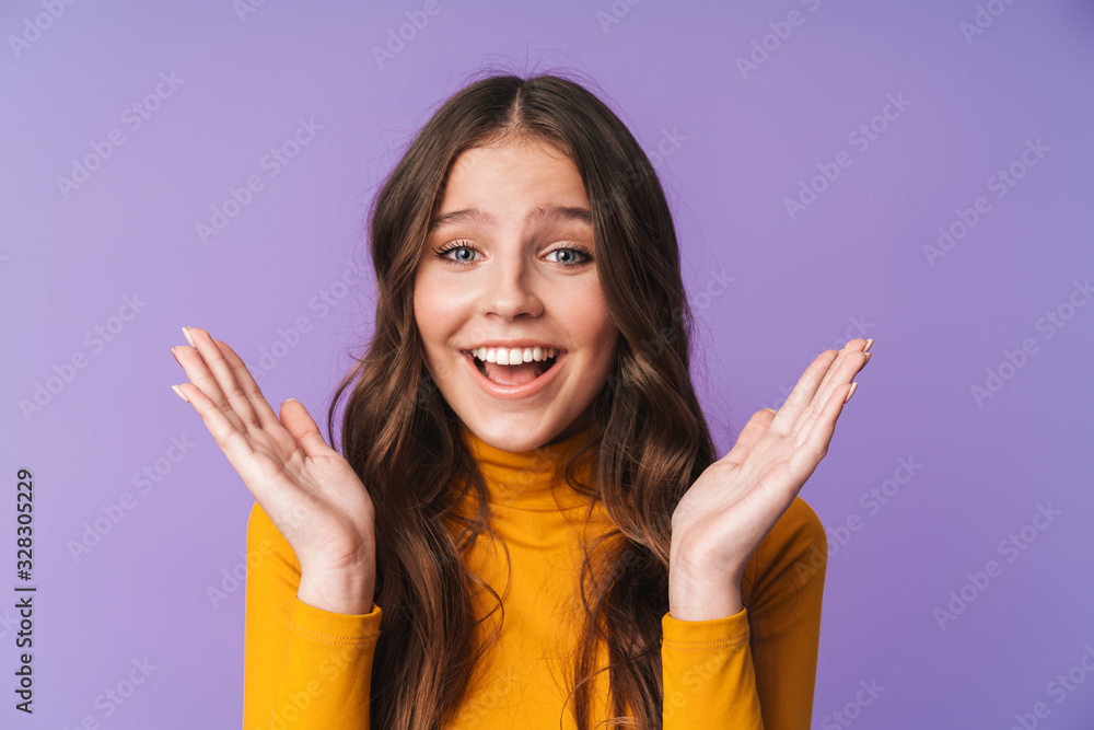 Image of young beautiful woman smiling and raising hands in delight Image of young beautiful woman smiling and raising hands in delight