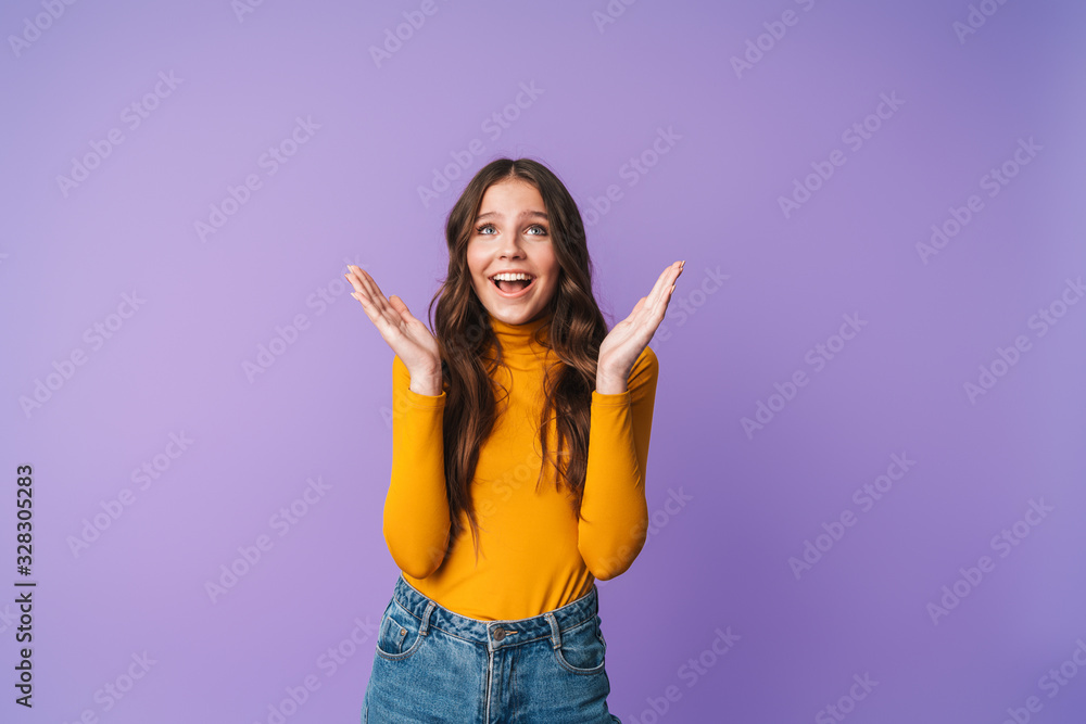 Image of young beautiful woman smiling and raising hands in delight Image of young beautiful woman smiling and raising hands in delight