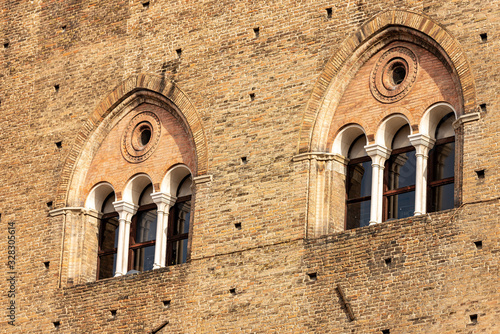 Closeup of two mullioned windows (trifore - triple lancet) of the medieval Palazzo Re Enzo (King Enzo palace, 1245) in Piazza del Nettuno, Bologna downtown, Emilia-Romagna, Italy, Europe photo