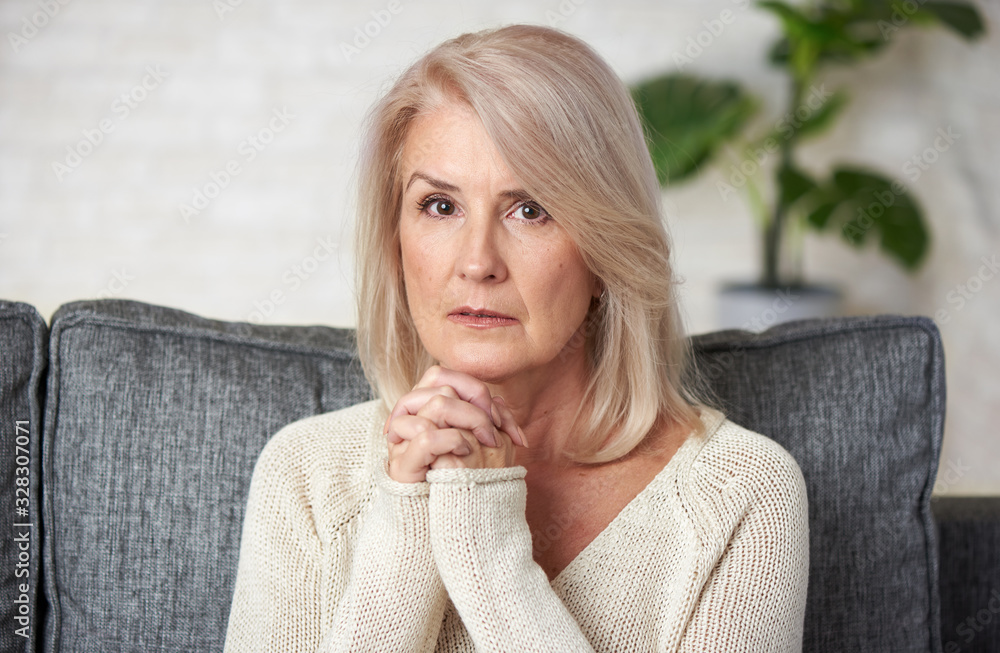 Portrait of a 60 years old pensive mature woman Stock Photo