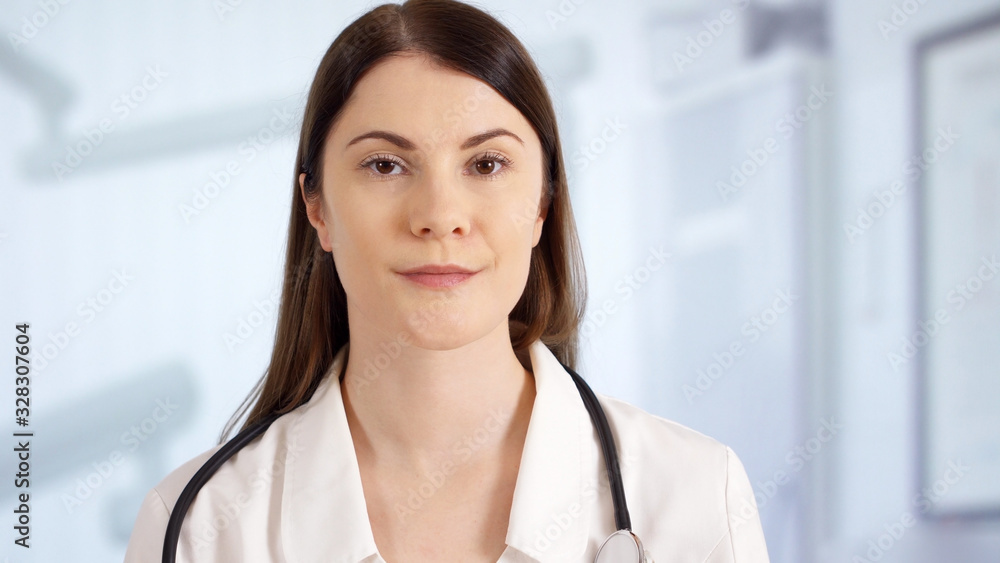 Portrait of confident professional female doctor standing in hospital room. Woman physician at work Portrait of confident professional female doctor standing in hospital room. Woman physician at work