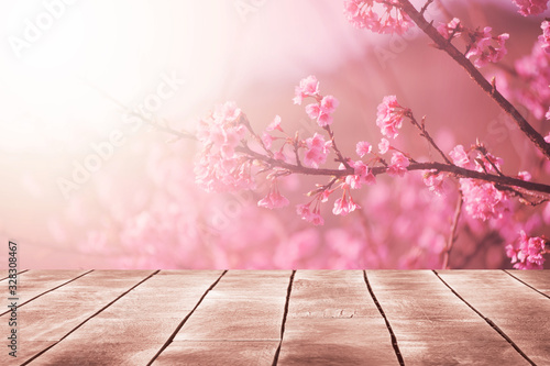 Spring seasonal of pink sakura branch with wooden table stand ,flower background