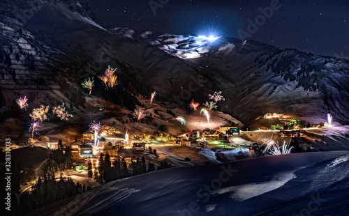 The Austrian ski resort Warth in the snowy Alps with New Year rockets.