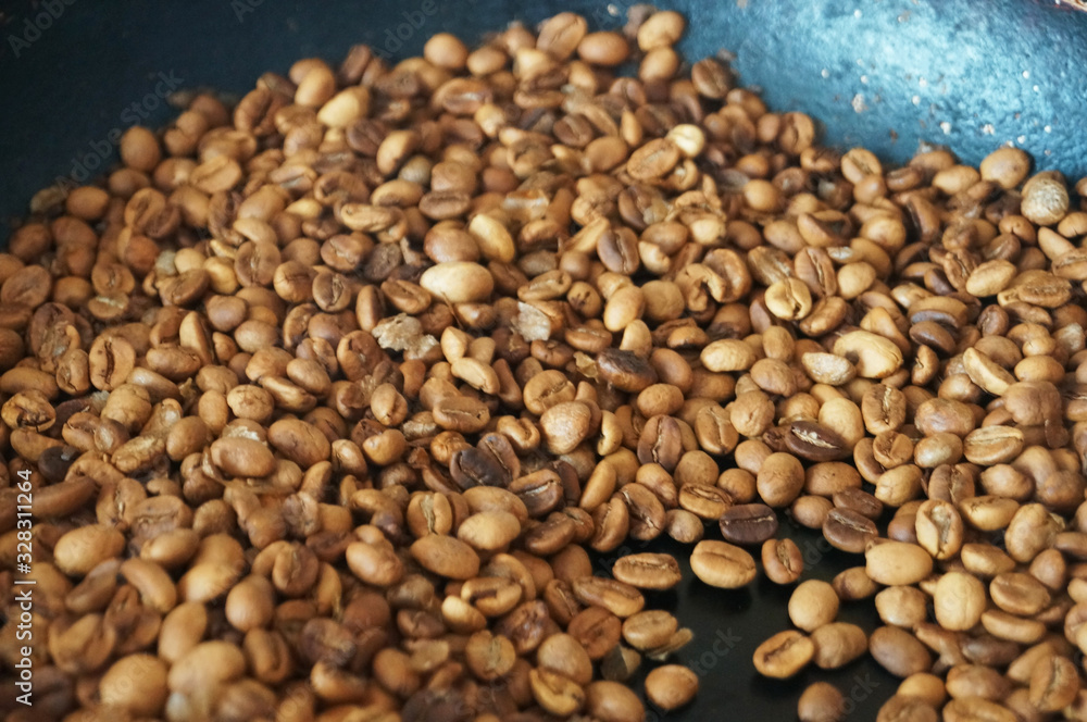 Coffee beans roasted to golden and brown are on the counter in the store Coffee beans roasted to golden and brown are on the counter in the store