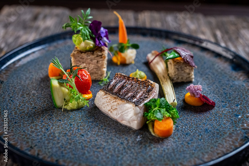 grilled sea bass fillet with cooked vegetables and potato pie