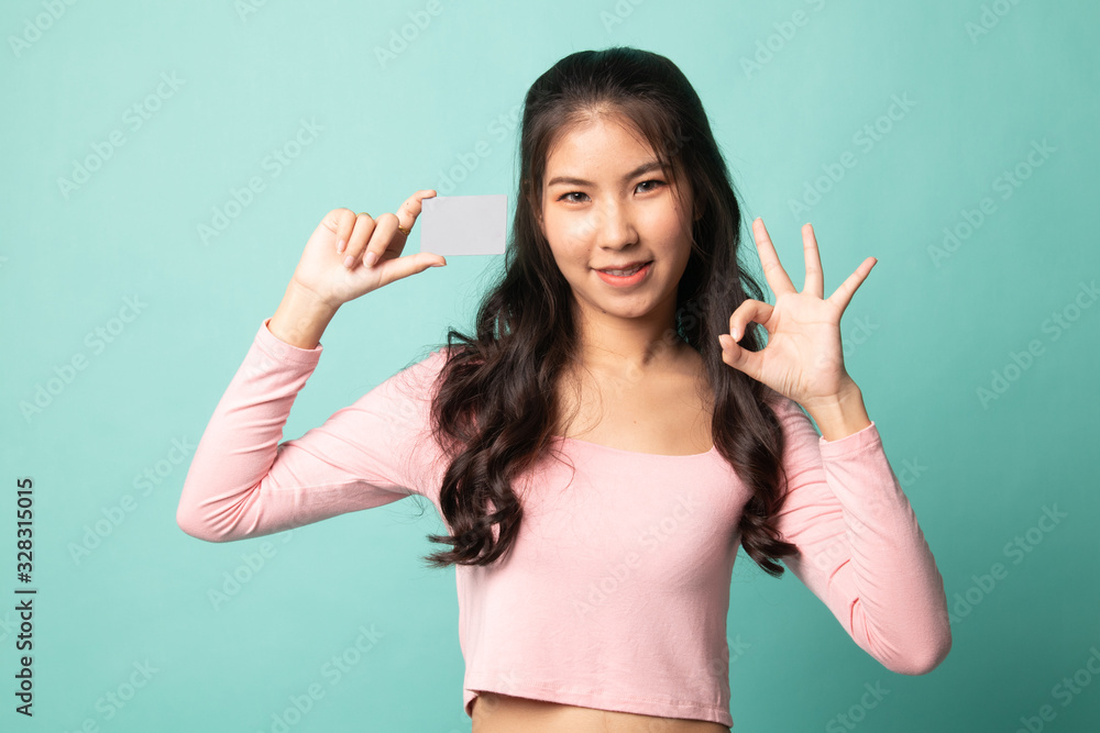 Young Asian woman show OK with a blank card. Young Asian woman show OK with a blank card.
