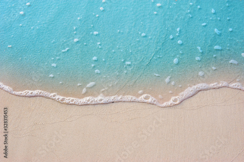 Blue ocean with soft wave form and fine sandy beach Summer background concept