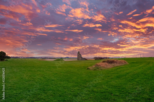 The Sun Sets on the Old Engine House of the Auchenharvie Colliery in Stevenston Scotland with a dramatic Blazing Red Sky. photo