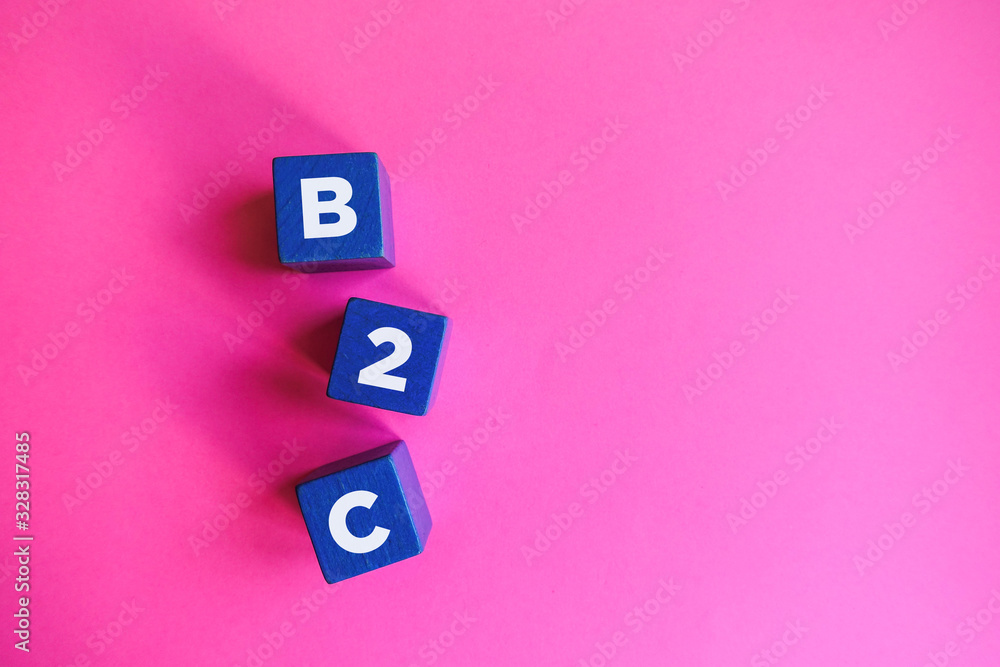 B2C - Business to Consumer, blue cubes on pink background. B2C - Business to Consumer, blue cubes on pink background.