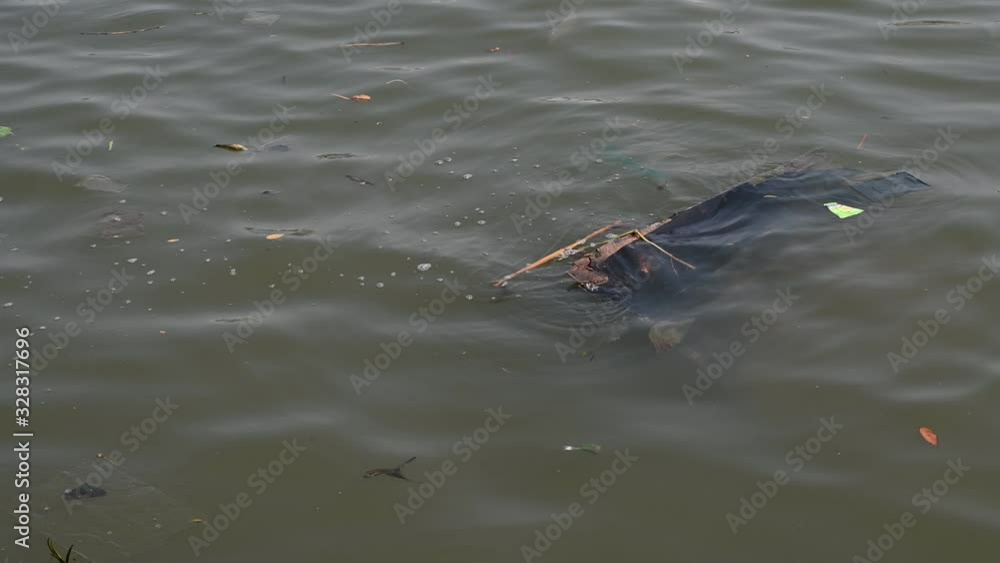 4K Environmental pollution. Plastic bottles, bags, too many trash in river, lake. Rubbish and pollution floating in water. Save river and water concept idea background. 4K Environmental pollution. Plastic bottles, bags, too many trash in river, lake. Rubbish and pollution floating in water. Save river and water concept idea background.