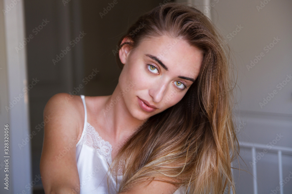Close up Young beautiful woman portrait on bed at home. Model fashion shooting. Beauty lady woman with white perfect smile and perfect skin looking at camera at home, elegant white face Close up Young beautiful woman portrait on bed at home. Model fashion shooting. Beauty lady woman with white perfect smile and perfect skin looking at camera at home, elegant white face