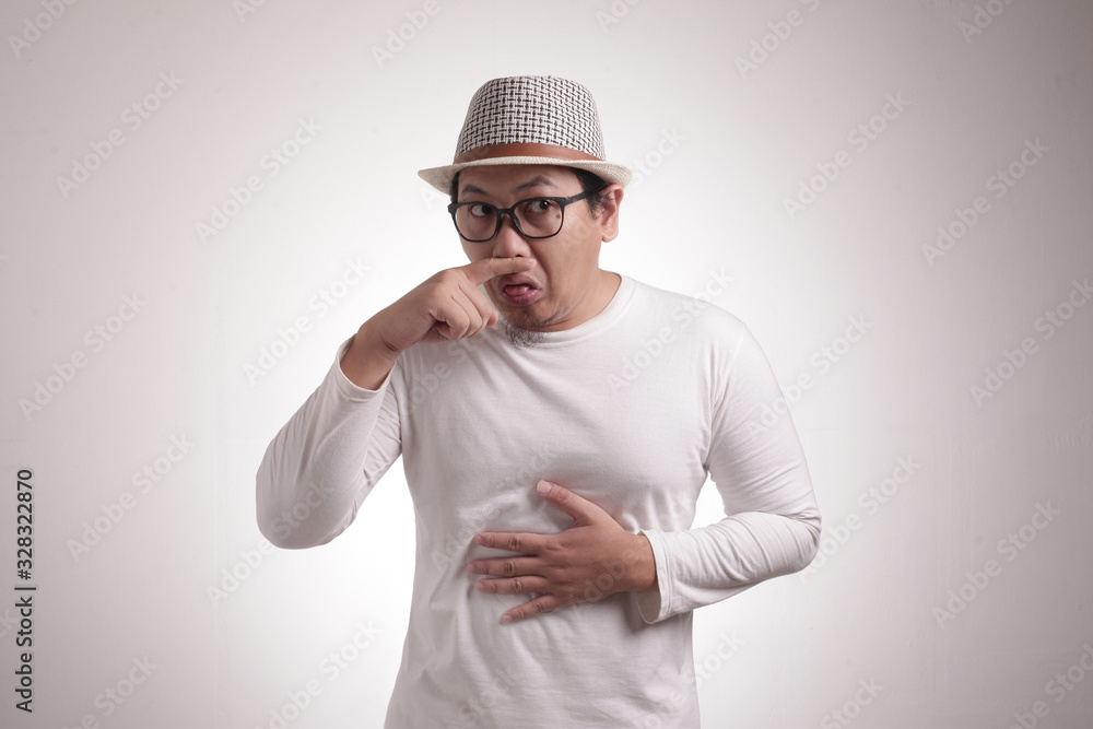 Young Man Close His Nose, Smells Something Bad Young Man Close His Nose, Smells Something Bad