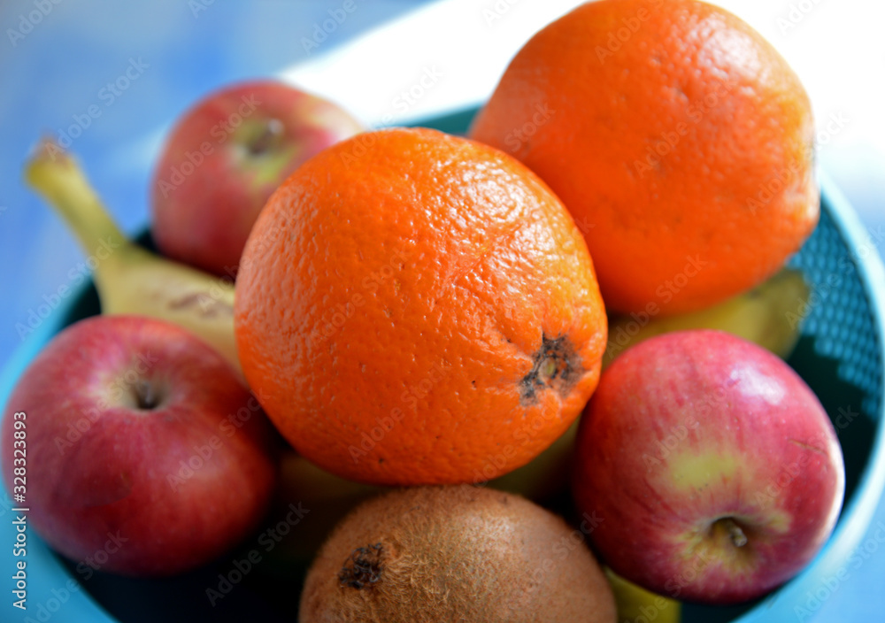 fresh fruits in a basket on wooden background fresh fruits in a basket on wooden background